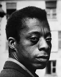 James Baldwin, novelist and essayist, photographed in his later years — whose essays in The Fire Next Time, Notes of a Native Son, and Nobody Knows My Name made him the civil rights movement's most powerful literary voice and one of the most important writers of the twentieth century.