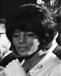 Vivian Malone Jones, one of the two Black students who registered at the University of Alabama on June 11, 1963, walking past Governor George Wallace's stand in the schoolhouse door to become the first Black student to graduate from the University of Alabama.