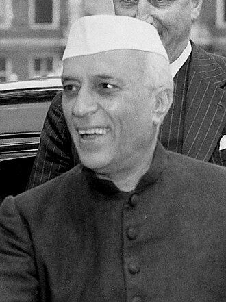 Jawaharlal Nehru, first Prime Minister of independent India, photographed in his characteristic white Nehru jacket and red rose